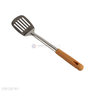 Good quality stainless steel slotted spatula with wooden handle